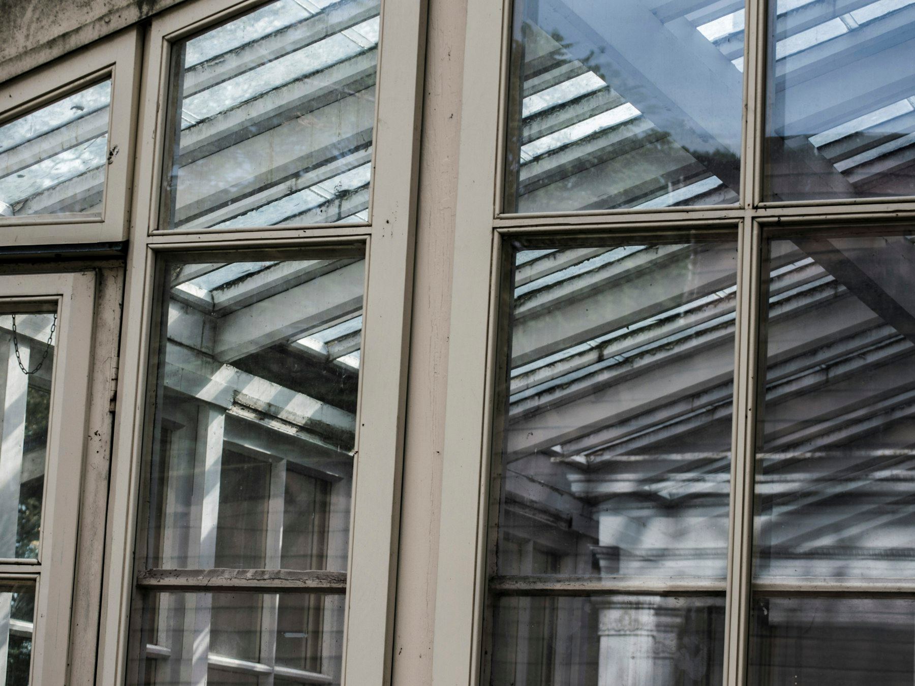 Close-up of a brown wooden framed glass conservatory window.